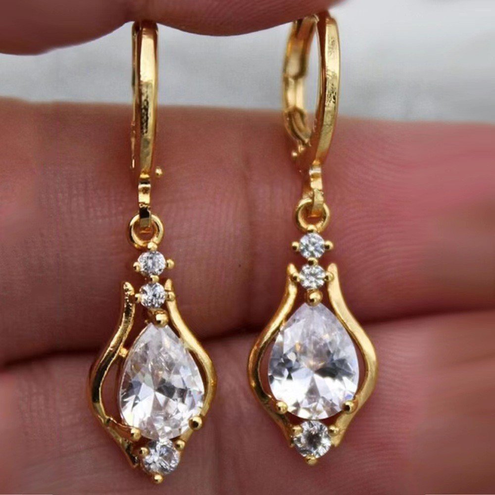 Gold-tone teardrop drop earrings with faceted accents